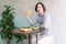 Portrait of young Asian man eating at restaurant table healthy food, drinking orange juice, dining alone and looking away, tourist