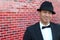 Portrait of young asian man wearing tuxedo and a fancy hat