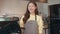 Portrait young Asian woman barista feeling happy smiling at urban cafe. Small business owner Korean girl in apron relax toothy