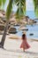 Portrait young asian woman smile happy around beach sea ocean with coconut palm tree for holiday vacation