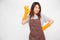 Portrait of young Asian woman wearing orange rubber gloves for hands protection during cleaning and showing ok sign.