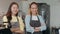 Portrait young Asian women barista feeling happy with friend at urban cafe. Small business owner Korean girl in apron relax toothy