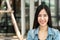 Portrait of young attractive asian woman looking at camera smiling with confident and positive lifestyle concept at outdoor cafe.