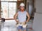 Portrait of young attractive builder man on his 20s posing happy confident and proud at construction site wearing protection helme