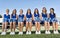 Portrait of young attractive Cheerleading Squad Sitting on Bench