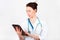 Portrait of young attractive doctor, surgeon, nurse with stethoscope and tablet