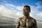 Portrait of young attractive and fit black afro American man with strong muscular body posing cool model attitude on the beach