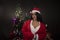 Portrait of young and attractive Indian Bengali brunette woman in red and white Santa Clause lingerie in Christmas.