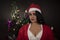 Portrait of young and attractive Indian Bengali brunette woman in red and white Santa Clause lingerie in Christmas.