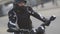 Portrait of young attractive motorcyclist with black helmet on street. Man motorcycle biker