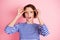 Portrait of young attractive shocked amazed pretty girl hold french fries on eyebrows isolated on pink color background