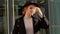 Portrait young attractive smile woman in hat and black coat look at camera at city center feel happy fashion girl face