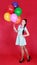 Portrait of a young attractive woman holding bunch of many bright balloons