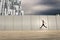 Portrait of young and attractive woman jumping next to the wall.