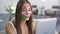 Portrait of young attractive woman with painted social media icons on her face talking with her friend using camera on