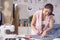 Portrait of a young, attractive woman on a stylish fashion designer`s table, surrounded by color textile samples. Attractive woma