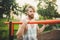 Portrait young bearded man standing on public sports ground and training on parallel bars. Handsome workout athlete. Portrait