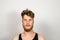 Portrait of young bearded unkempt scruffy man on gray background