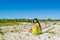 Portrait of young beautiful asian girl sitting at the top of the hill facing camera