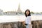 Portrait young beautiful asian woman smiling while travel at Wat Arun sunset view point, Bangkok, Thailand