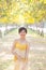 Portrait of young beautiful asian woman wearing yellow long dres