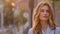 Portrait of young beautiful attractive pensive woman girl caucasian lady student stands on street in city in yellow