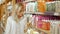 Portrait of Young Beautiful Blonde Woman Reading Label of Shampoo In Supermarket