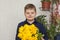 Portrait of a young, beautiful boy. Holds a huge armful of fresh yellow tulips. The concept of spring and holiday, March 8,