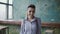 Portrait of young beautiful caucasian woman in modern coworking space. Businesswoman looking at camera, smiling,