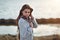 Portrait of a young beautiful charismatic brunette girl in a coat on the coast of the sea