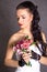 Portrait of a young beautiful fiancee with a bunch of pink flowers