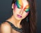 Portrait of a young beautiful girl with a fashion bright multicolored makeup