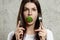 Portrait of a young, beautiful girl holding a broccoli in her mouth.. The concept of a healthy diet, detox, weight loss, diet,