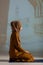 Portrait of a young and beautiful Muslim woman in red hijab dress sitting and meditating in the mosque