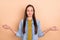 Portrait of young beautiful peaceful female doing yoga with closed eyes wear denim shirt isolated on beige color