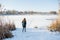 Portrait of a young beautiful red hair girl crossing frozen river