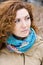 Portrait of a young beautiful redheaded girl in a bright scarf
