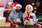 Portrait of a young beautiful smiling couple. Christmas couple. winter freands wearing red santa claus hat. Sensual