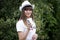 Portrait of young beautiful smiling girl in hat with cocktail glass with straw in hand in outdoor. Summer mood