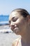 Portrait of young beautiful teenager. Funny face of girl on the beach by the sea