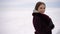 Portrait of a young beautiful woman on a background of snow. High quality FullHD footage
