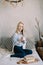 Portrait of a young beautiful woman in bed in the morning at home. Blonde girl in scandinavian interior. Good morning. Lifestyle.