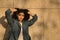 Portrait of young and beautiful woman, brunette, with curly hair, jacket with hands in her hair and seductive look. Concept beauty