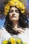 Portrait of young beautiful woman circlet of flowers on head