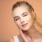 Portrait of young beautiful woman with a healthy  skin of face.  Attractive girl with a bunch spring field flowers