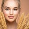 Portrait of young beautiful woman with a healthy  skin of face.  Attractive girl with a bunch spring field flowers