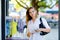 Portrait of young beautiful woman holding medical mask as protection against corona virus. Woman shopping in the city