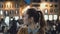 Portrait of young beautiful woman standing in the city centre in evening. Student girl looks at camera, smiling.