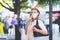 Portrait of young beautiful woman wearing medical mask as protection against corona virus. Woman shopping in the city