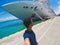 Portrait of a young black male tourist in front of a cruise ship on cloudy sky. African tourist on the beach trip